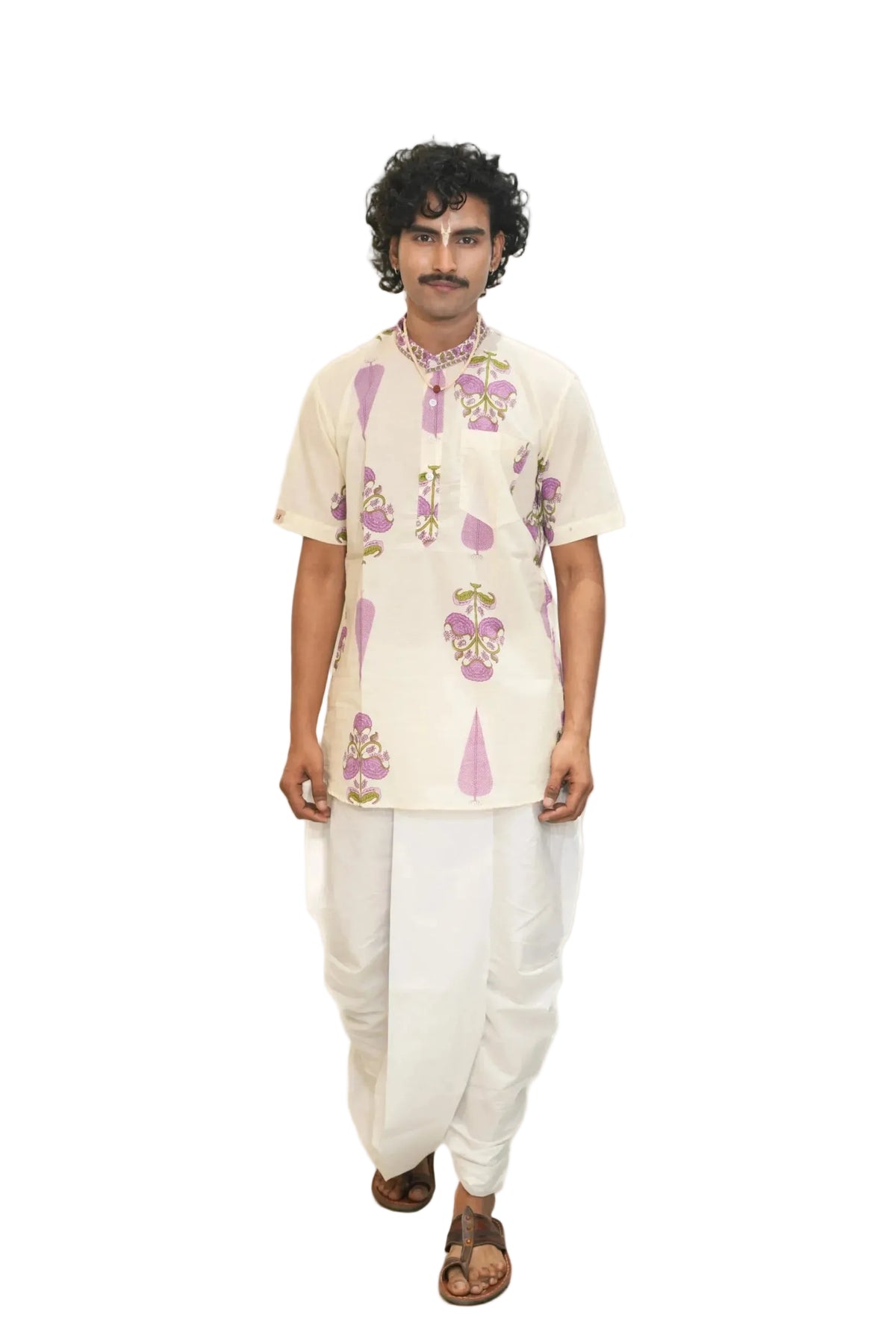 Man wearing a floral kurta with white pants on a white background